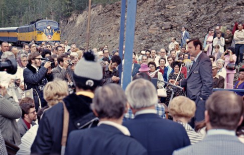 Administrator John W. Ingram of the Federal Railroad Administration makes a speech at the 50th anniversary golden spike ceremony for the Alaska Railroad near Nenana, Alaska, on July 15, 1973. Photograph by Leo King, © 2015, Center for Railroad Photography and Art. King-02-041-009