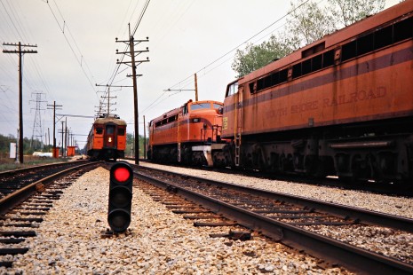Westbound South Shore Line passenger train meeting an eastbound freight train at Dune Acres, Indiana, on April 23, 1977. Photograph by John F. Bjorklund, © 2015, Center for Railroad Photography and Art. Bjorklund-42-07-04