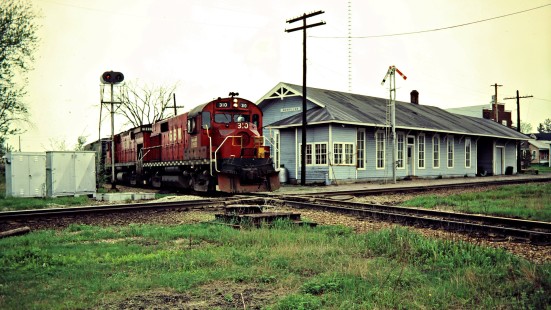 Eastbound Green Bay and Western Railroad freight train at station in Merrillan, Wisconsin, on May 13, 1982. Photograph by John F. Bjorklund, © 2015, Center for Railroad Photography and Art. Bjorklund-43-09-05