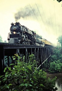 Eastbound Chesapeake and Ohio Railway passenger excursion train led by stream locomotive no. 614 crossing bridge in Grand Ledge, Michigan, on June 13, 1981. Photograph by John F. Bjorklund, © 2015, Center for Railroad Photography and Art. Bjorklund-35-07-18