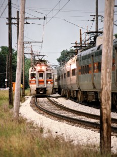 Eastbound and westbound South Shore Line passenger trains passing in Michigan City, Indiana, on June 15, 1991. Photograph by John F. Bjorklund, © 2015, Center for Railroad Photography and Art. Bjorklund-42-21-04