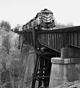 Southbound Missouri–Kansas–Texas Railroad grain train crosses high bridge at Stringtown, Oklahoma, in March 1988. Photograph by J. Parker Lamb, © 2016, Center for Railroad Photography and Art. Lamb-02-048-06