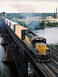 Westbound Chicago and North Western Railway freight train crossing the Chippewa River in Eau Claire, Wisconsin, on August 9, 1982. Photograph by John F. Bjorklund, © 2015, Center for Railroad Photography and Art. Bjorklund-27-23-19