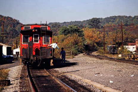 Conductor on the caboose of a southbound Clinchfield Railroad freight train receiving orders in St. Paul, Virginia, on October 15, 1980. Photograph by John F. Bjorklund, © 2015, Center for Railroad Photography and Art. Bjorklund-41-18-14