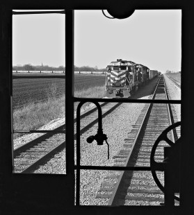 Southbound Missouri–Kansas–Texas Railroad rock train pulls long consist (left) onto main line at Granger, Texas. View is from caboose of Missouri Pacific Railroad train waiting for meet in March 1970. Photograph by J. Parker Lamb, © 2016, Center for Railroad Photography and Art. Lamb-02-044-07