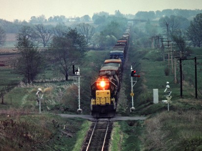 Westbound Chicago and North Western Railway freight train passing semaphores and wig-wags in Friesland, Wisconsin, on May 12, 1982. Photograph by John F. Bjorklund, © 2015, Center for Railroad Photography and Art. Bjorklund-27-22-09
