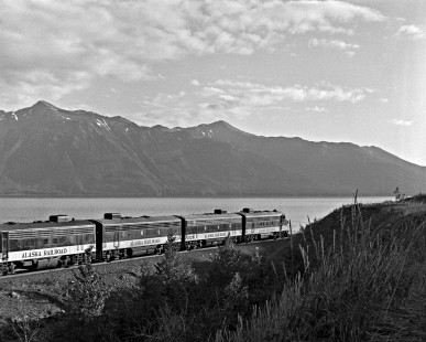 Alaska Railroad EMD F7A locomotive no. 1508 leads a quartet of F units and a northbound passenger train along Turnagain Arm near Rainbow, c. 1973. Photograph by Leo King, © 2015, Center for Railroad Photography and Art. King-03-041-005