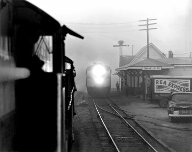 On a foggy morning in February 1962, Seaboard Air Line's northbound <i>Tidewater</i> passenger train arrives at Franklin, Virginia, as seen from local freight train no. 85. Photograph by J. Parker Lamb, © 2016, Center for Railroad Photography and Art. Lamb-01-081-07