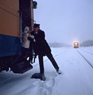 Crewman helping child exit Alaska Railroad passenger train, c. 1968. Photograph by Leo King, © 2015, Center for Railroad Photography and Art. King-02-034-003