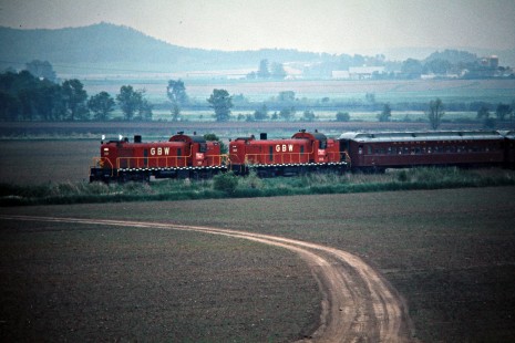 Eastbound Green Bay and Western Railroad Alco RS2 locomotives with Algoma Central passenger cars in Hixton, Wisconsin, on May 29, 1976. Photograph by John F. Bjorklund, © 2015, Center for Railroad Photography and Art. Bjorklund-43-03-12