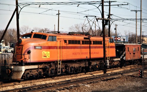 Eastbound South Shore Line electric locomotive no. 803 and caboose at Hammond, Indiana, on March 26, 1973. Photograph by John F. Bjorklund, © 2015, Center for Railroad Photography and Art. Bjorklund-42-06-18