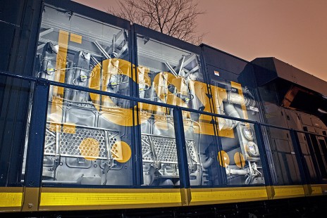 With what appears to be x-ray vision, the camera captures a double exposure depicting the engine interior of a CSXT GE ES44AH.  Bold colors and dynamic lines add to the fascination of the image.