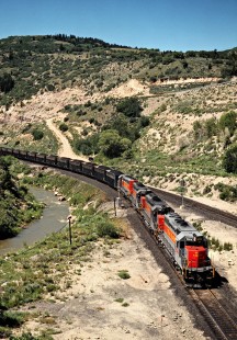Helper locomotives shoving a westbound Utah Railway coal train on the Southern Pacific's former Denver & Rio Grande Western line over Soldier Summit in Kyune, Utah, on July 7, 1993. The Rio Grande acquired the much larger Southern Pacific in 1988, but retained the name of the bigger road. Photograph by John F. Bjorklund, © 2015, Center for Railroad Photography and Art. Bjorklund-49-13-17