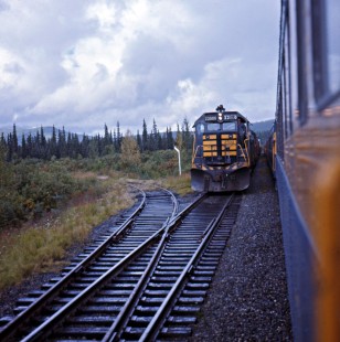 Alaska Railroad passenger train meeting a freight train led by EMD GP35 locomotive no. 2502 in Alaska, c. 1968. Photograph by Leo King, © 2015, Center for Railroad Photography and Art. King-02-014-003