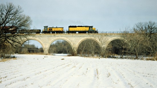 Eastbound Chicago and North Western Railway freight train crossing bridge in Tiffany, Wisconsin, on January 26, 1980. Photograph by John F. Bjorklund, © 2015, Center for Railroad Photography and Art. Bjorklund-26-23-20