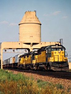 Westbound Chicago and North Western Railway freight train and coaling tower in Nelson, Illinois, on August 6, 1983. Photograph by John F. Bjorklund, © 2015, Center for Railroad Photography and Art. Bjorklund-27-24-13