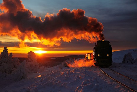 In one of those magic moments in the Harz Mountains in Germany, the sun near the horizon has dropped below heavy clouds to provide golden light just as the steam powered train approaches.