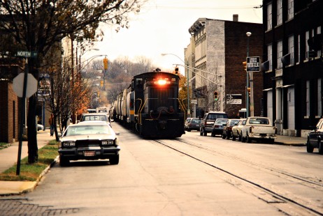 Northbound CSX Transportation freight train running down the middle of North 5th Street in Lafayette, Indiana, on November 6, 1987. Photograph by John F. Bjorklund, © 2015, Center for Railroad Photography and Art. Bjorklund-35-26-12