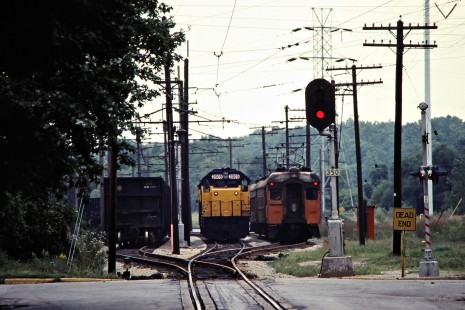 Westbound South Shore Line passenger train passing eastbound freight locomotives at Michigan City, Indiana, on September 5, 1981. Photograph by John F. Bjorklund, © 2015, Center for Railroad Photography and Art. Bjorklund-42-12-16