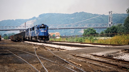 Westbound Conrail freight train along the Ohio River at Steubenville, Ohio, on July 1, 1989. Market Street Bridge is in the background. Photograph by John F. Bjorklund, © 2015, Center for Railroad Photography and Art. Bjorklund-30-28-14