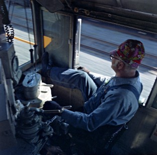 Alaska Railroad engineer Kenny Fuller inside cab of EMD GP7L locomotive no. 1839 on the Whittier Shuttle train, c. 1968. Photograph by Leo King, © 2015, Center for Railroad Photography and Art. King-02-043-005
