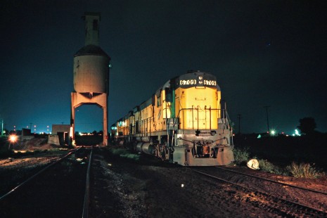 Chicago and North Western Railway Alco locomotives at night next to the coaling tower in Escanaba, Michigan, on August 23, 1975. Photograph by John F. Bjorklund, © 2015, Center for Railroad Photography and Art. Bjorklund-24-17-11.