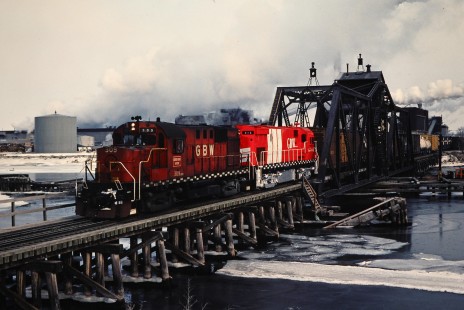 Westbound Green Bay and Western Railroad freight train crossing bridge in Green Bay, Wisconsin, on February 27, 1982. Photograph by John F. Bjorklund, © 2015, Center for Railroad Photography and Art. Bjorklund-43-06-16
