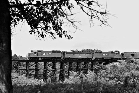 Northbound Missouri–Kansas–Texas Railroad inspection train crosses trestle after departing Smithville, Texas, in May 1966. Photograph by J. Parker Lamb, © 2016, Center for Railroad Photography and Art. Lamb-02-041-05