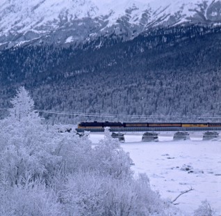Alaska Railroad passenger train crossing snowy bridge, c. 1968. Photograph by Leo King, © 2015, Center for Railroad Photography and Art. King-02-038-010