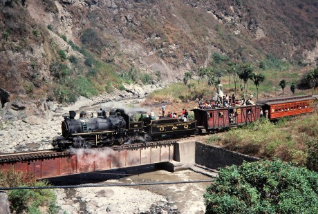 Guayaquil and Quito Railway steam locomotive no. 44 leads passenger train across a bridge near Alausi, Chimborazo, Ecuador, on July 31, 1988. Photograph by Fred M. Springer, © 2014, Center for Railroad Photography and Art, Springer-ECU1-17-20