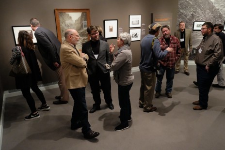 Drake Hokanson, Alexander Craghead, and Carol Kratz discuss the "After Promontory" exhibition during the reception on Friday. Photograph by Scott Lothes.