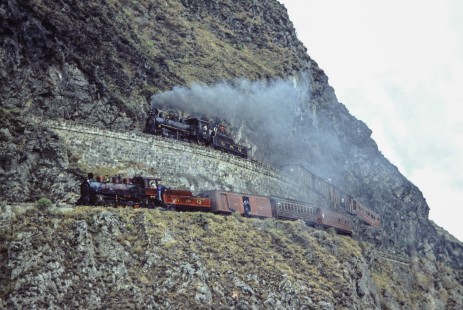 Two Guayaquil-Quito Railway steam locomotives with passenger trains at the Nariz del Diablo (Devil's Nose)  near Riobamba, Chimborazo, Ecuador, on July 9, 1990. Photograph by Fred M. Springer, © 2014, Center for Railroad Photography and Art, Springer-ECU1-24-02