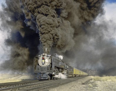 Union Pacific Railroad steam locomotive no. 8444 leads westbound excursion train at Rock River, Wyoming on May 11, 1968. Train is en route between Denver, Colorado and Rawlins, Wyoming. Photograph by Victor Hand; Hand-UP-C64-10.JPG;