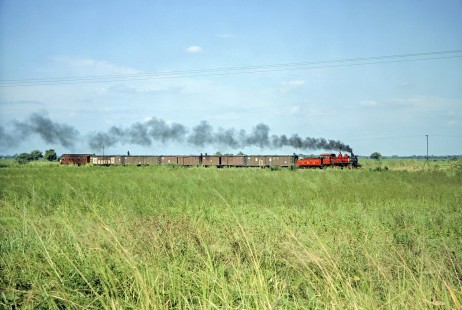 Guayaquil-Quito Railway steam locomotive no. 7 hauls a freight train and a rider coach near Casiguana, Guayas,  Ecuador, on July 8, 1990. Photograph by Fred M. Springer, © 2014, Center for Railroad Photography and Art, Springer-ECU1-22-17