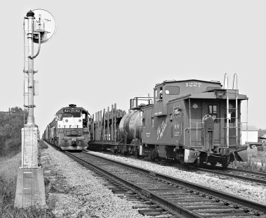 Frisco SD45 and freight train wait for Memphis run to pass siding at Sulligent, Alabama, in August 1974. Photograph by J. Parker Lamb, © 2016, Center for Railroad Photography and Art. Lamb-02-004-02
