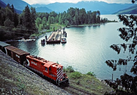 Northbound Canadian Pacific Railway local freight train led by GP9 no. 8820 at Slocan Lake in Rosebery, British Columbia, on July 14, 1983. The train has just completed a trip across the lake on the barge in the background. Photograph by John F. Bjorklund, © 2015, Center for Railroad Photography and Art. Bjorklund-38-08-09