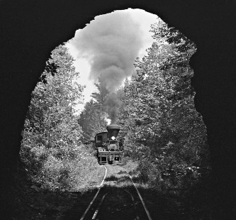 Twin Seams Mining Company Shay no. 5 and train approach short, summit tunnel at Kellerman, Alabama, in December 1959. (Lamb notes that the "slow speed of locomotive allowed me to exit tunnel by running in front of train." Such practices would not be condoned today.) Photograph by J. Parker Lamb, © 2016, Center for Railroad Photography and Art. Lamb-02-037-02