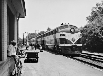 Atlanta-bound West Point Route <i>Crescent</i> passenger train pulls into station at Auburn, Alabama, in July 1952, under watchful eyes of curious youngster, as well as an older resident (left) who seems to like watching trains come and go. Photograph by J. Parker Lamb, © 2016, Center for Railroad Photography and Art. Lamb-02-020-01