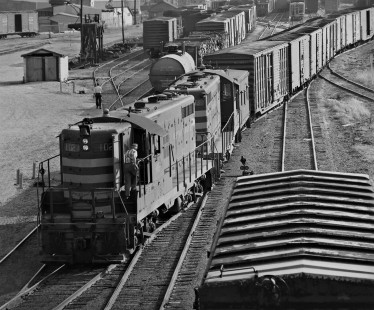 In late afternoon Meridian and Bigbee Railroad Geeps shove their freight train through Gulf, Mobile and Ohio Railroad yard in Meridian, Mississippi, en route to interchange yard in August 1958. Photograph by J. Parker Lamb, © 2016, Center for Railroad Photography and Art. Lamb-02-034-01