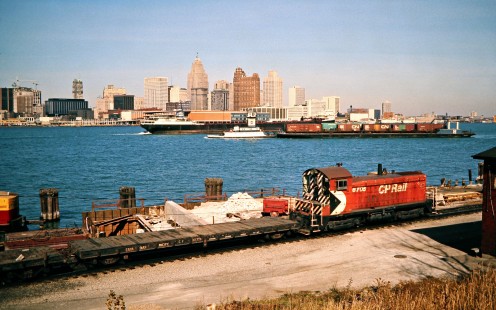 Canadian Pacific Railway freight train at Windsor, Ontario, with car float, <i>Ernest R. Breech</i> lake boat, downtown Detroit in background, on October 26, 1974. Photograph by John F. Bjorklund, © 2015, Center for Railroad Photography and Art. Bjorklund-37-15-15