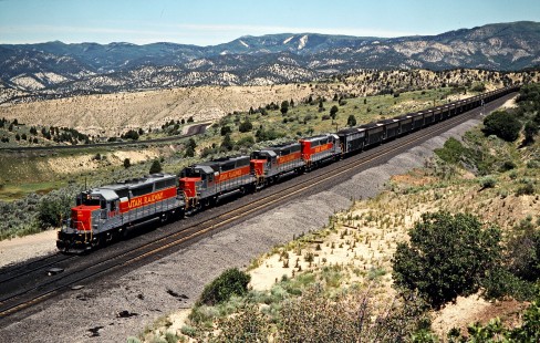 Westbound Utah Railway coal train at Gilluly Loop on the Southern Pacific's former Denver & Rio Grande Western line over Soldier Summit in Gilluly, Utah, on July 7, 1993. The Rio Grande acquired the much larger Southern Pacific in 1988, but retained the name of the bigger road. Photograph by John F. Bjorklund, © 2015, Center for Railroad Photography and Art. Bjorklund-49-13-13