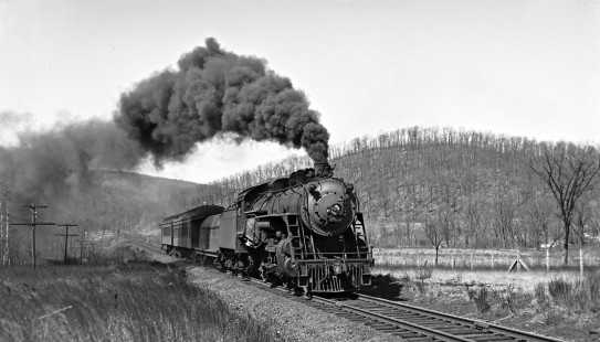 Delware, Lackawanna and Western Railroad 4-6-0 steam locomotive no. 1008 leads eastbound passenger train on Sussex Branch in Waterloo, New Jersey on April 3, 1941. Photograph by Donlad Furler. Furler-24-107-02.JPG; © 2017, Center for Railroad Photography and Art