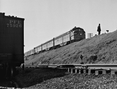 Illinois Central Railroad's speedster, <i>City of New Orleans</i>, passenger train departs station at Jackson, Mississippi, as switchman waits to resume yard work in August 1954. Photograph by J. Parker Lamb, © 2016, Center for Railroad Photography and Art. Lamb-02-020-10
