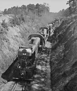 Birmingham-bound Central of Georgia Railway freight train no. 29 slices through a cut south of Opelika, Alabama, in March 1954. Absence of leading F-unit was unusual during this period. Photograph by J. Parker Lamb, © 2016, Center for Railroad Photography and Art. Lamb-02-007-04