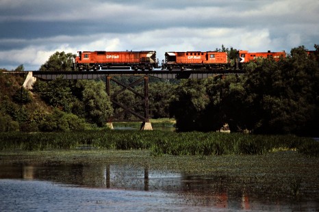 Westbound Canadian Pacific Railway freight train led by M630 locomotive no. 4568 crossing the Thames River in Thamesford, Ontario, on September 4, 1982. Photograph by John F. Bjorklund, © 2015, Center for Railroad Photography and Art. Bjorklund-37-18-10