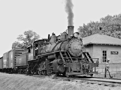 Crewman heads out to flag crossing before southbound Mississippian Railway freight train leaves station in Fulton, Mississippi, in May 1956. Photograph by J. Parker Lamb, © 2016, Center for Railroad Photography and Art. Lamb-02-029-07