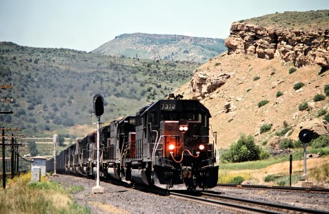Eastbound Southern Pacific Railroad freight train at Wolcott, Colorado, on the Denver and Rio Grande Western's line over Tennessee Pass on July 10, 1993. Rio Grande acquired the much bigger SP in 1988, but retain the name of the larger road. Photograph by John F. Bjorklund, © 2015, Center for Railroad Photography and Art. Bjorklund-49-15-09