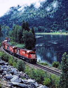 Eastbound Canadian Pacific Railway freight train along Kootenay River in Nelson, British Columbia, on July 13, 1983. Photograph by John F. Bjorklund, © 2015, Center for Railroad Photography and Art. Bjorklund-37-15-10
