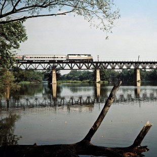 Eastbound Amtrak passenger train on Illinois Central Gulf Railroad bridge over the Fox River in South Elgin, Illinois, on September 1981. Photograph by John F. Bjorklund, © 2016, Center for Railroad Photography and Art. Bjorklund-60-17-15