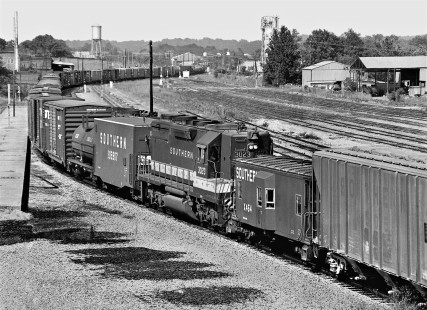 Mid-train view of southbound Southern Railway train no. 153 as it passes station in Meridian, Mississippi, showing radio-controlled helper locomotive and control car in April 1968. In the yard, the helper and cut of cars for Meridian were quickly detached, minimizing the train's yard delay. Photograph by J. Parker Lamb, © 2016, Center for Railroad Photography and Art. Lamb-01-111-04